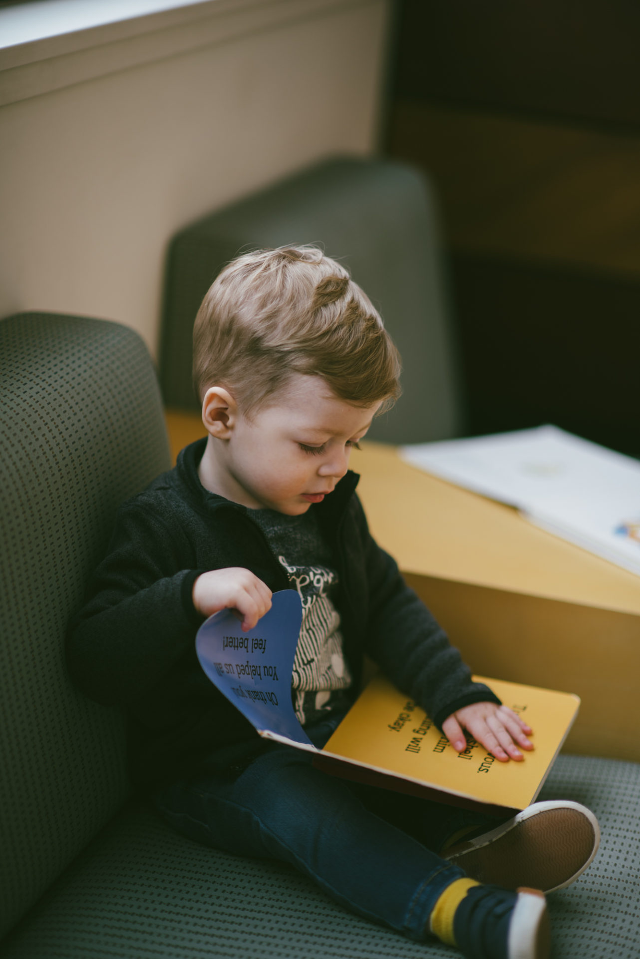 He's two! Reading books at the library.