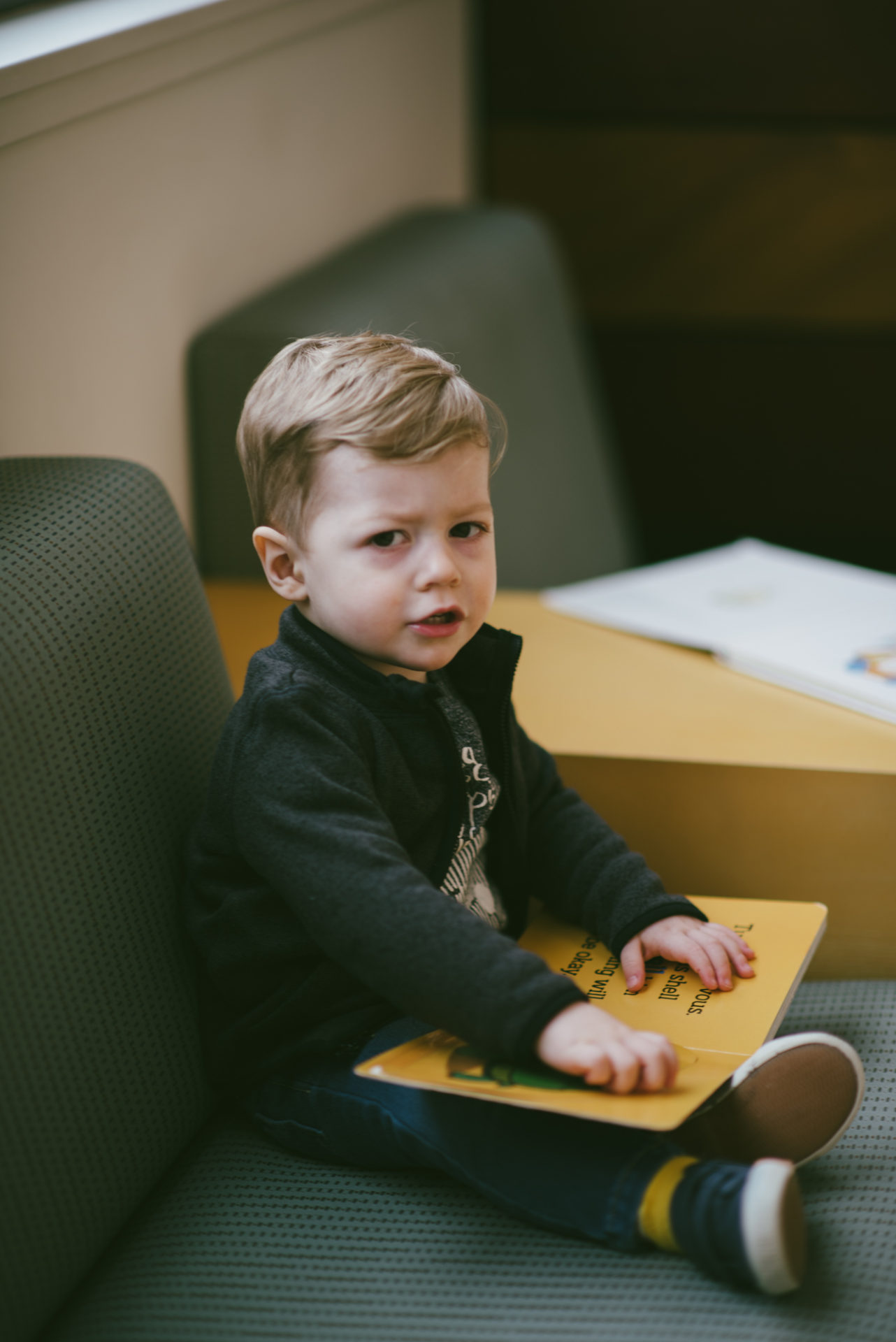 He's two! Reading books at the library.