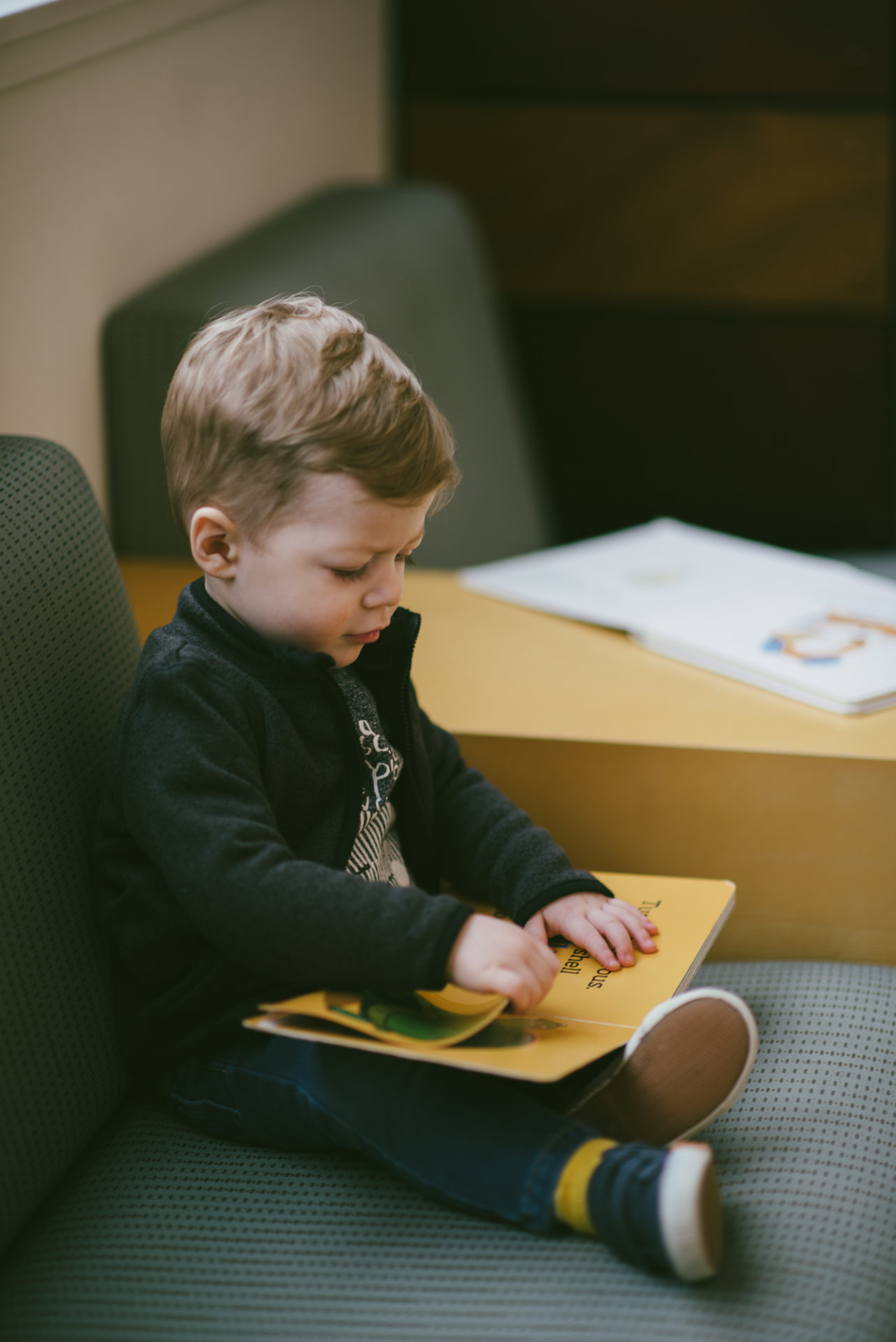 He's two! Reading books at the library.