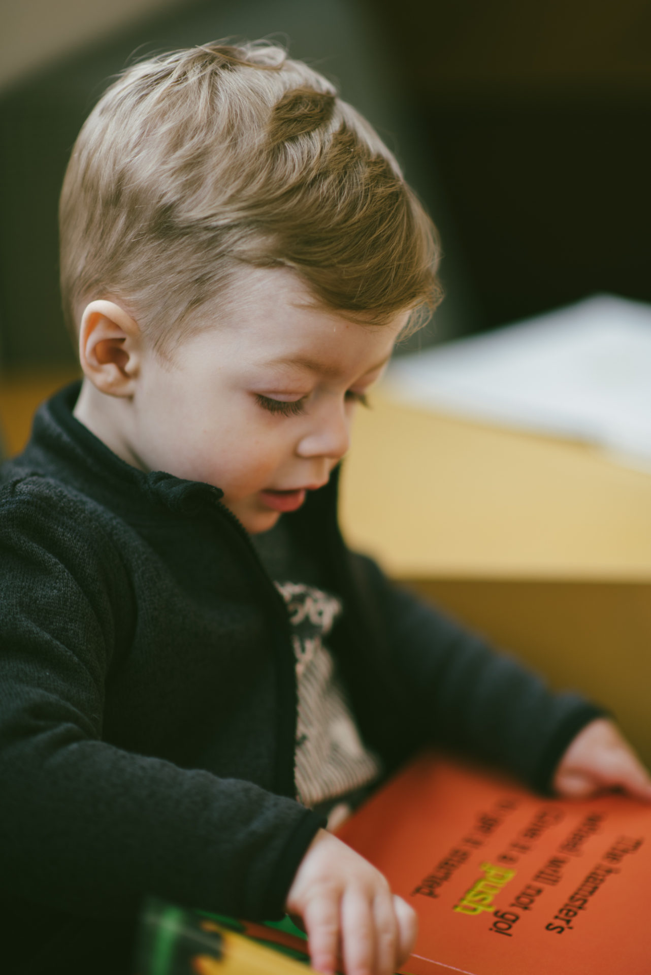 He's two! Reading books at the library.