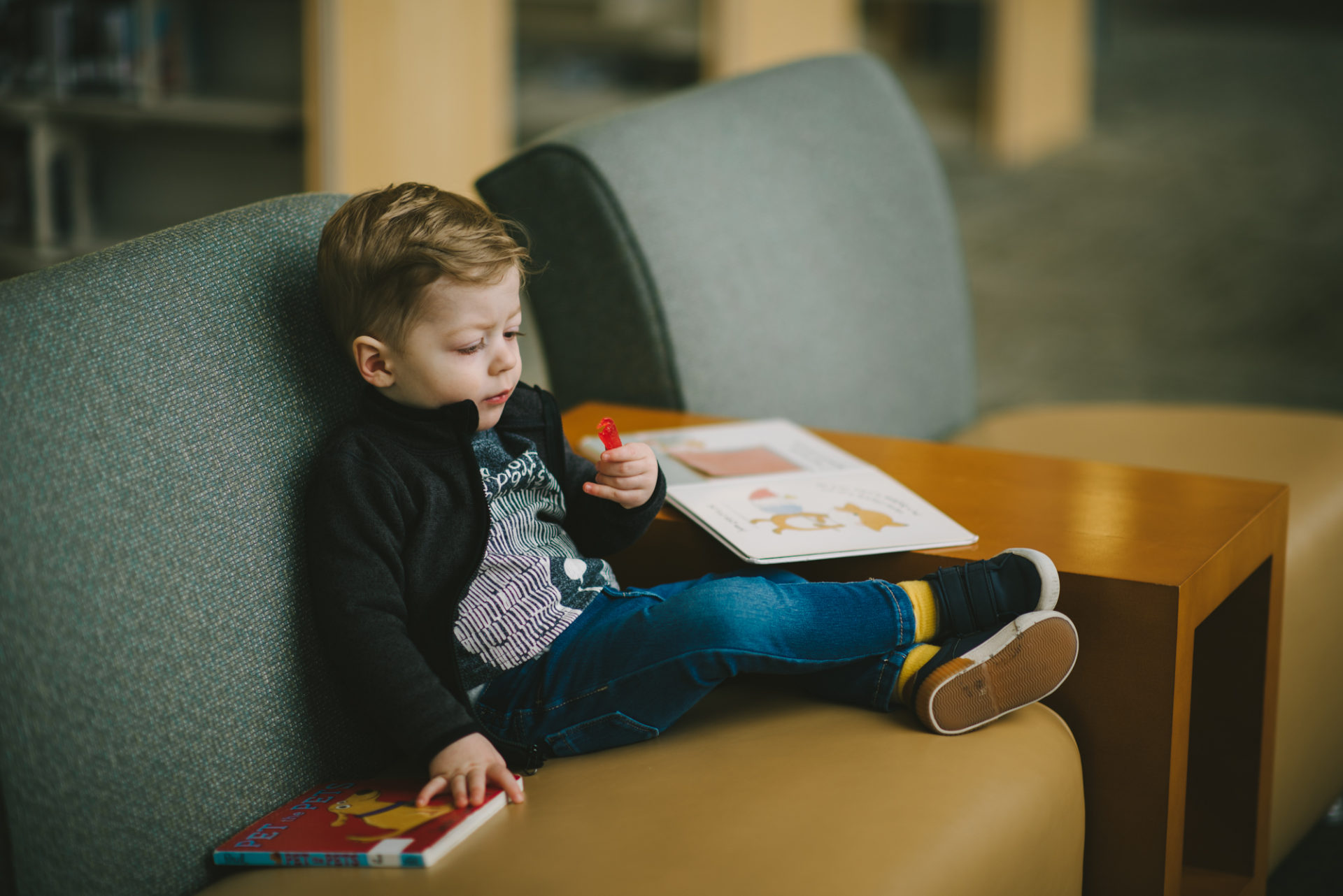 He's two! Reading books at the library.