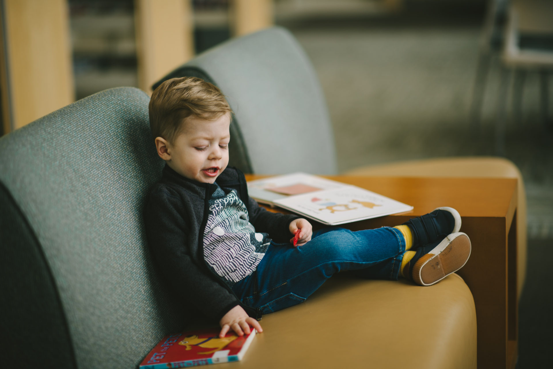 He's two! Reading books at the library.